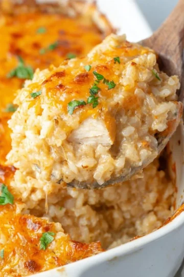 Delicious Chicken Rice Casserole topped with cheese and herbs