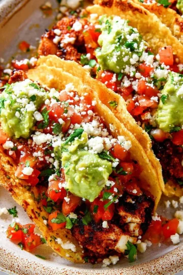 Plate of flavorful chicken street tacos topped with fresh ingredients
