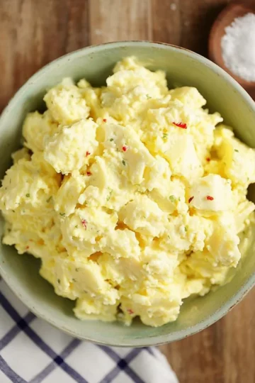 Bowl of Classic Southern Potato Salad garnished with paprika and parsley
