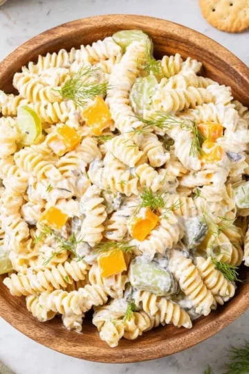 Delicious Dill Pickle Pasta Salad served in a bowl with fresh ingredients.