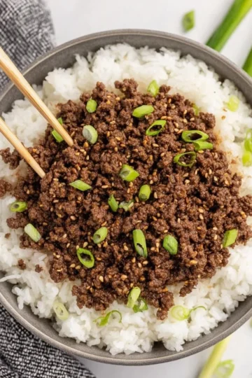 Delicious Korean Beef Bowl garnished with green onions and sesame seeds