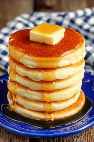 Fluffy Silver Dollar Pancakes served on a plate with syrup and berries