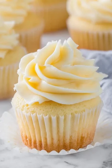 Delicious homemade vanilla cupcakes topped with creamy frosting