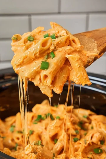 Bowl of Crock Pot Buffalo Chicken Pasta topped with green onions