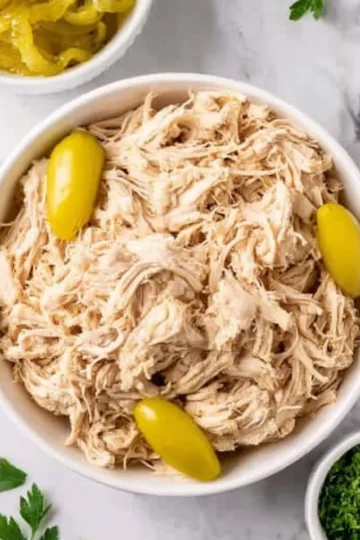 Delicious Crock Pot Mississippi Chicken served on a plate with herbs