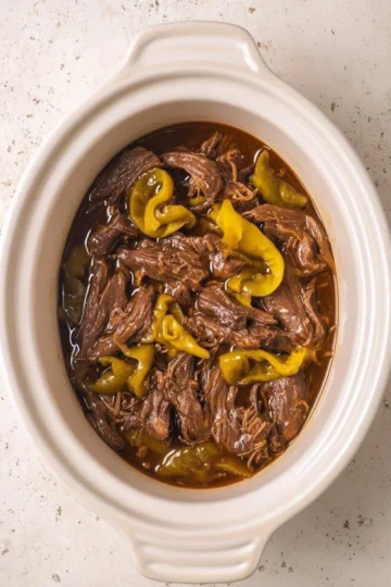 Delicious CrockPot Mississippi Pot Roast cooked to perfection with herbs and spices.