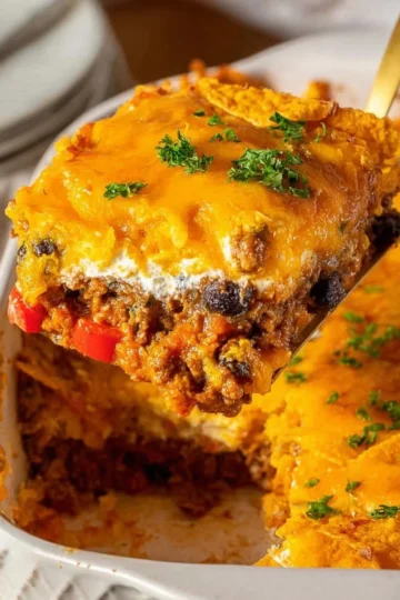 Delicious homemade Dorito Casserole topped with cheese and crunchy Doritos