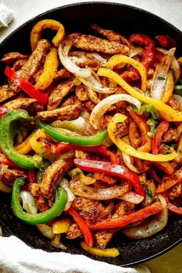 Plate of easy chicken fajitas with colorful peppers and onions
