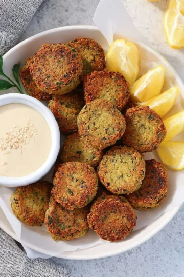 Delicious homemade falafel served with sauce on a plate, perfect for air fryer or oven.