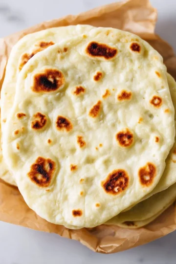 Homemade pita bread fresh out of the oven, perfect for wraps and dips