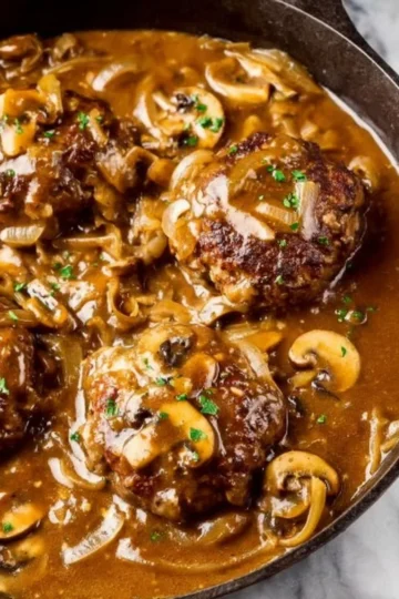 Delicious easy Salisbury steak recipe served with gravy and mashed potatoes