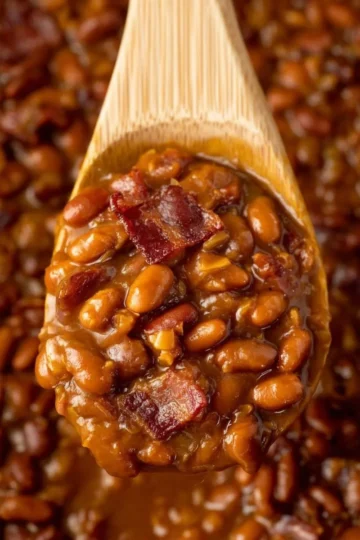Bowl of easy ultimate baked beans topped with seasoning and herbs.