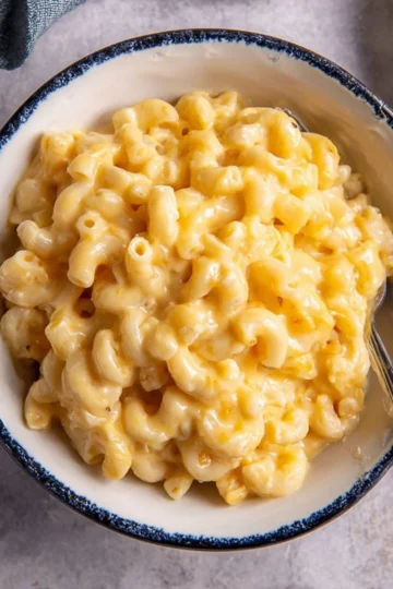 Creamy homemade mac and cheese served in a bowl with a golden crust