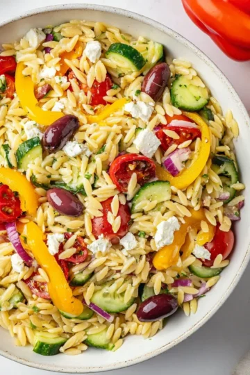 Colorful Orzo Pasta Salad with vegetables and dressing