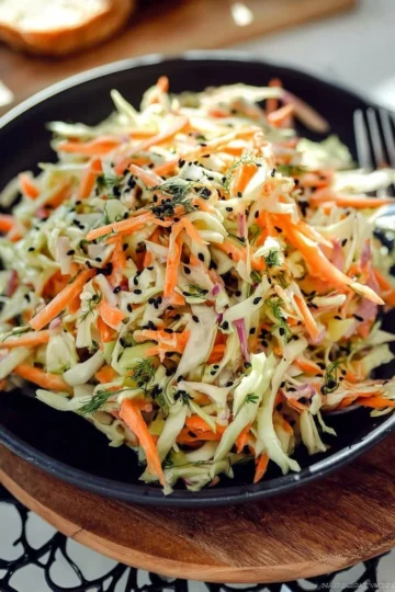 Colorful bowl of simple easy cabbage and carrot salad with dressing