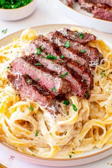 Delicious Steak Pasta Alfredo featuring tender steak and creamy sauce.