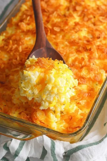 Delicious cheesy potato casserole topped with melted cheese and herbs