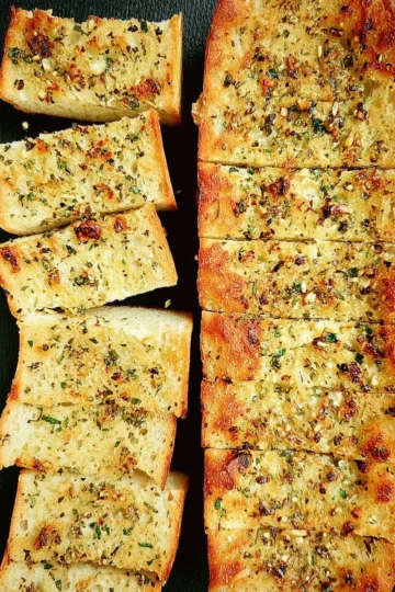 Deliciously golden and crispy garlic bread served with a side of marinara sauce.