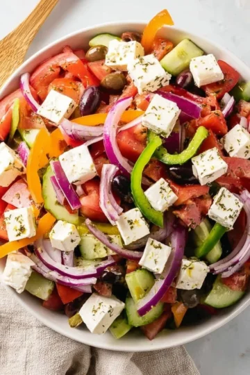 Traditional Greek Salad with fresh vegetables, olives, and feta cheese.