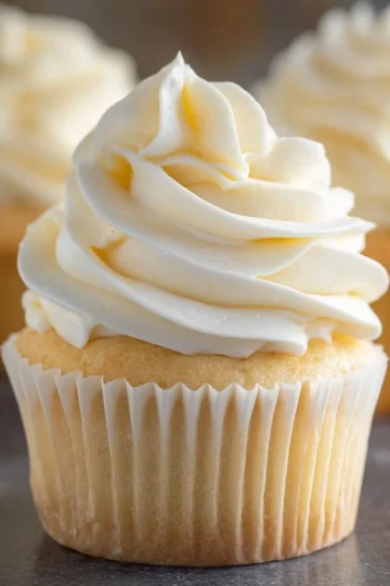 Delicious homemade vanilla buttercream frosting spread on a chocolate cake