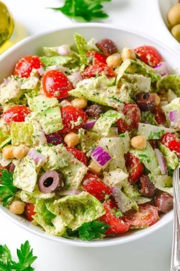 A vibrant Vegan Italian Salad with fresh vegetables and herbs.