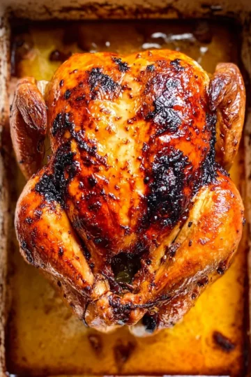 Vietnamese roasted chicken garnished with fresh herbs and spices