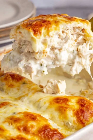 Delicious white chicken enchiladas topped with creamy sauce and cheese
