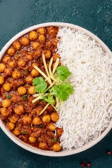 Delicious chickpea curry served in a bowl with fresh cilantro and spices.