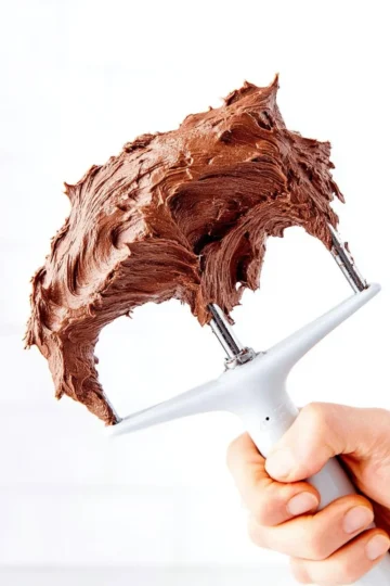 Delicious chocolate frosting on a cupcake with sprinkles