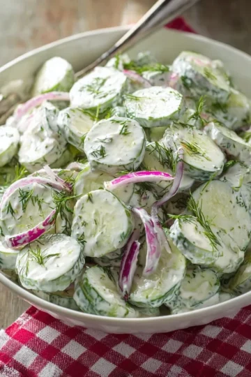 Refreshing creamy cucumber salad with fresh herbs and dressing