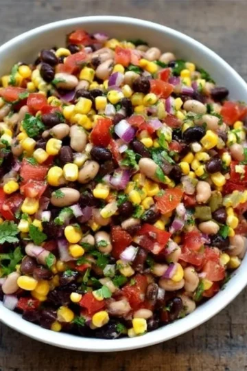 Bowl of easy Cowboy Caviar dip with vibrant vegetables and chips