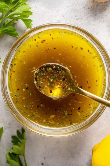 Bowl of homemade Italian dressing with herbs and spices
