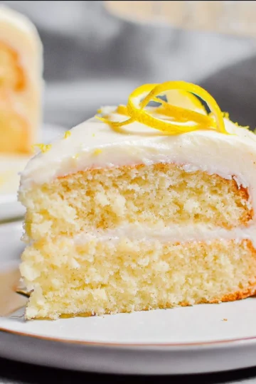 A moist and fluffy lemon cake topped with lemon frosting and zest