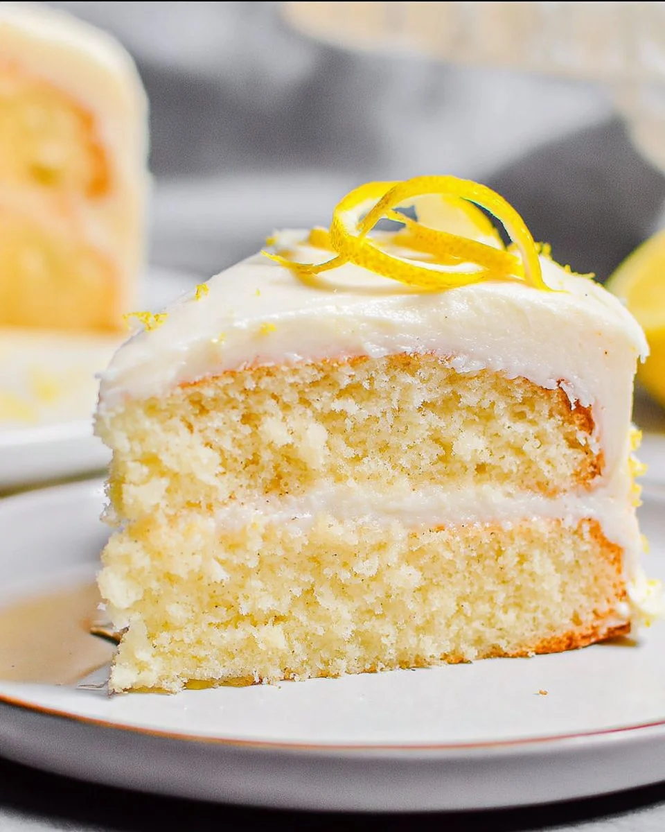 A moist and fluffy lemon cake topped with lemon frosting and zest