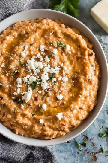 Bowl of quick and easy homemade refried beans with toppings