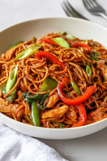 Bowls of quick and easy hoisin chicken noodles garnished with vegetables