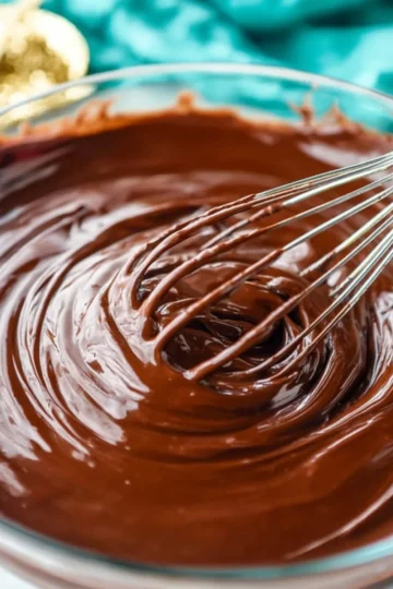 Delicious two-ingredient chocolate ganache ready for topping desserts.