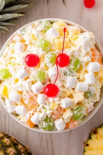 A colorful bowl of Hawaiian Ambrosia Salad with tropical fruits and coconut.